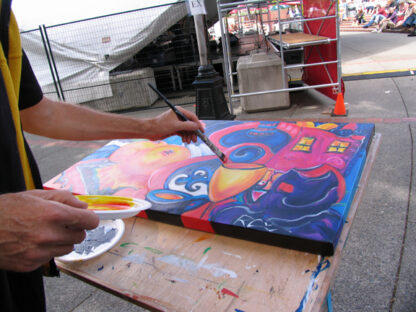 An image of Robert painting at a concert in Victoria, BC